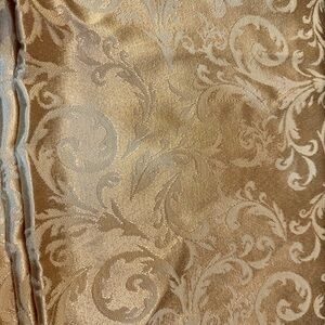 Beautiful gold colored silky tablecloth.  Like new condition. 59” x 98”.